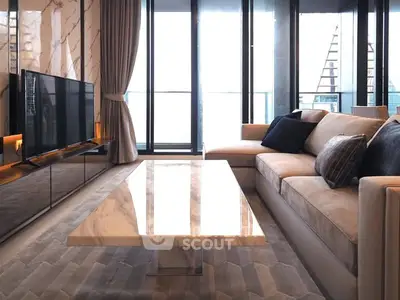 Luxurious modern living room with marble accents and large windows offering stunning views.