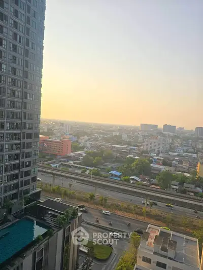 Stunning cityscape view from high-rise building with pool and sunset horizon.