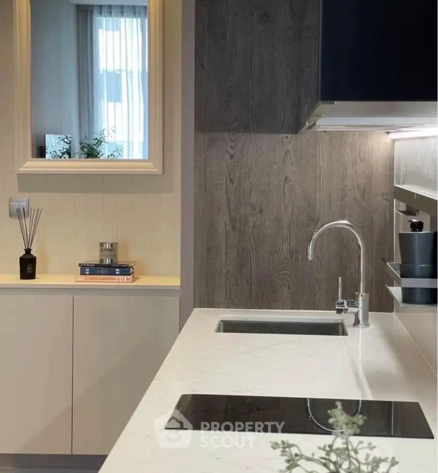 Modern kitchen with sleek countertops and stylish cabinetry, perfect for contemporary living.