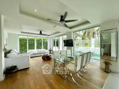 Luxurious open-plan living and dining area with pool view and modern decor