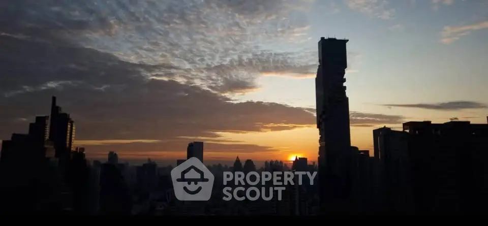 Stunning city skyline view at sunset with iconic skyscrapers silhouetted against a vibrant sky.