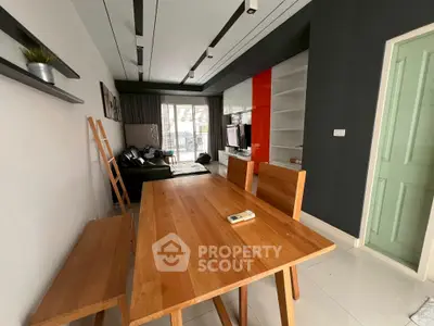 Modern living room with wooden dining table and sleek decor