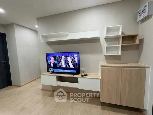 Modern living room with sleek wooden furniture and mounted TV, perfect for cozy entertainment.