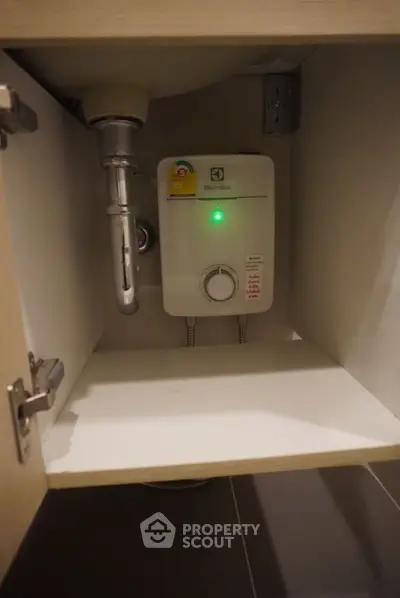 Compact under-sink water heater in modern kitchen cabinet
