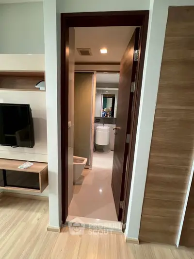 Modern apartment interior with bathroom view and sleek wooden flooring