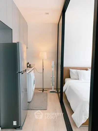 Modern studio apartment with sleek kitchen and cozy bedroom