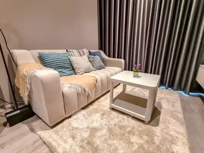 Cozy living room with plush sofa and elegant decor, perfect for relaxation.