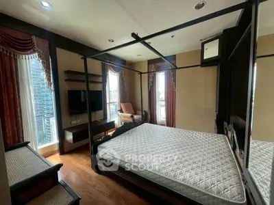 Luxurious bedroom with elegant drapes and city view, featuring a stylish four-poster bed and modern amenities.
