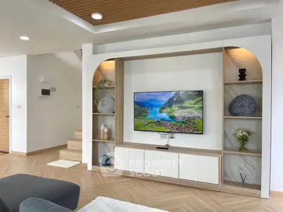 Modern living room with stylish built-in TV unit and elegant decor