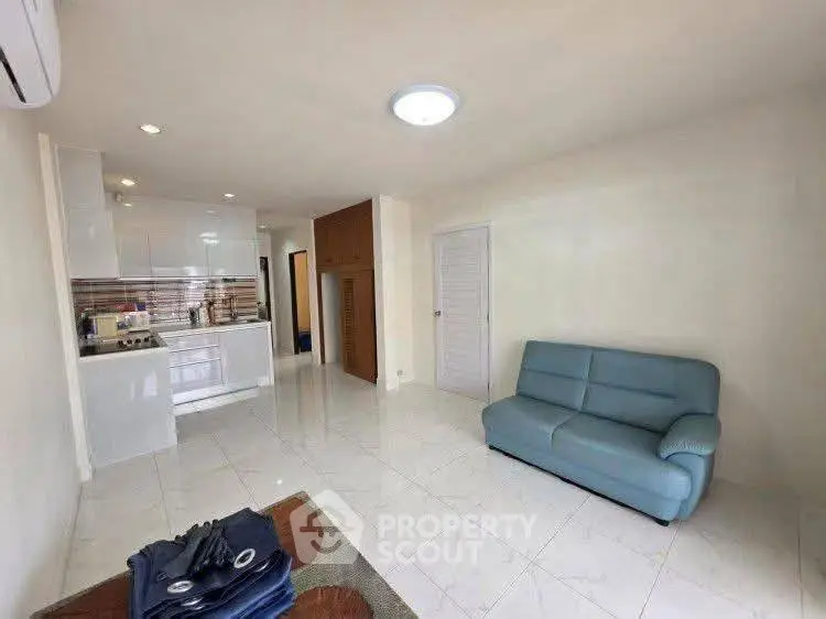 Spacious living room with modern kitchen in open layout apartment