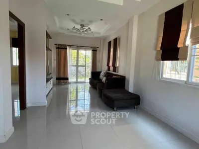 Spacious living room with modern decor and large windows offering natural light.