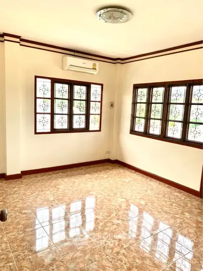 Bright and spacious living room with tiled floors and large windows