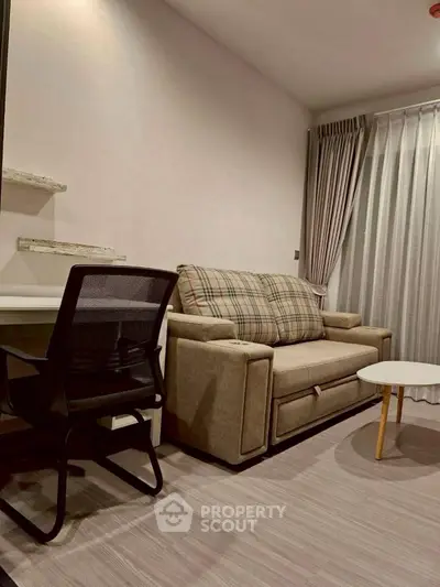 Cozy living room with modern sofa and work desk, perfect for urban living.