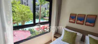 Luxurious bedroom with pool view, modern decor, and vibrant artwork, perfect for a serene living experience.