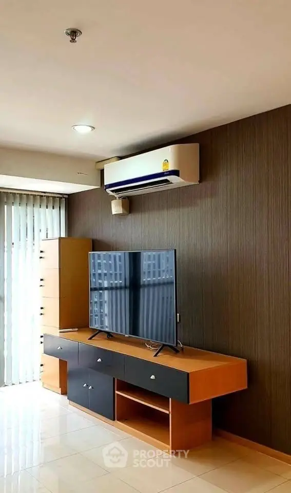 Modern living room with sleek TV unit and air conditioning, perfect for comfortable living.