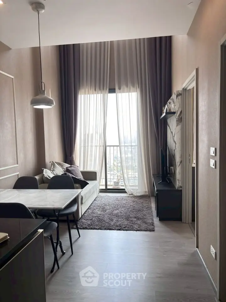 Modern living room with high ceilings, elegant curtains, and a cozy dining area, offering a stunning city view.