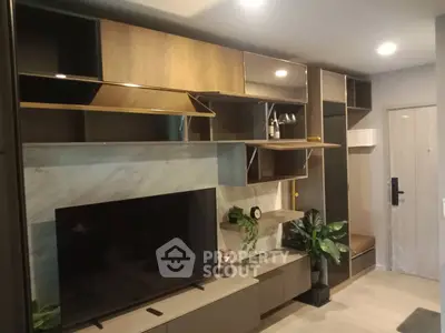 Modern living room with stylish shelving and large TV, perfect for entertainment and relaxation.
