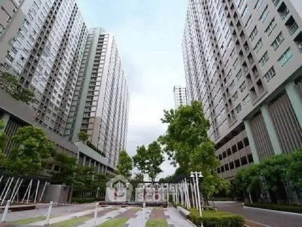 Modern high-rise residential buildings with lush green landscaping