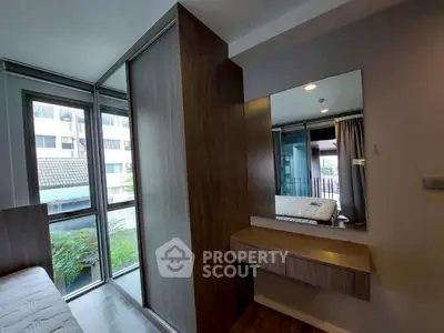 Modern bedroom with large windows and built-in wooden wardrobe