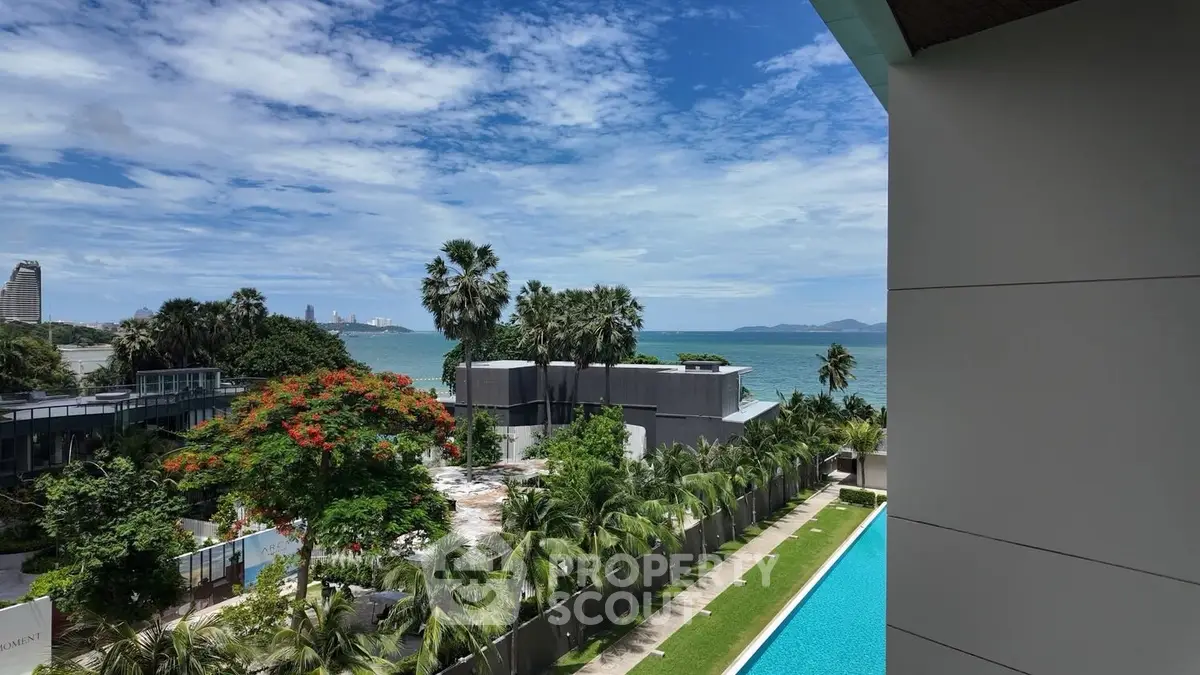 Stunning ocean view from luxury condo with pool and lush greenery