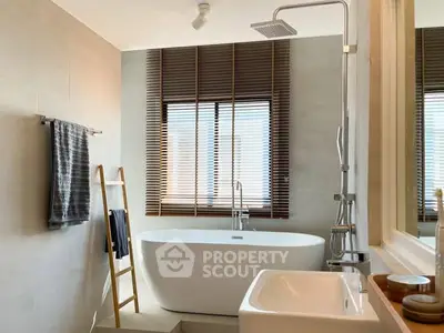 Modern bathroom with freestanding tub and stylish blinds