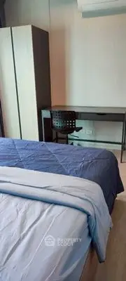 Modern bedroom with sleek desk and cozy bedding