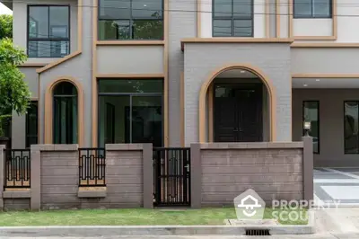 Modern townhouse exterior with stylish facade and gated entrance