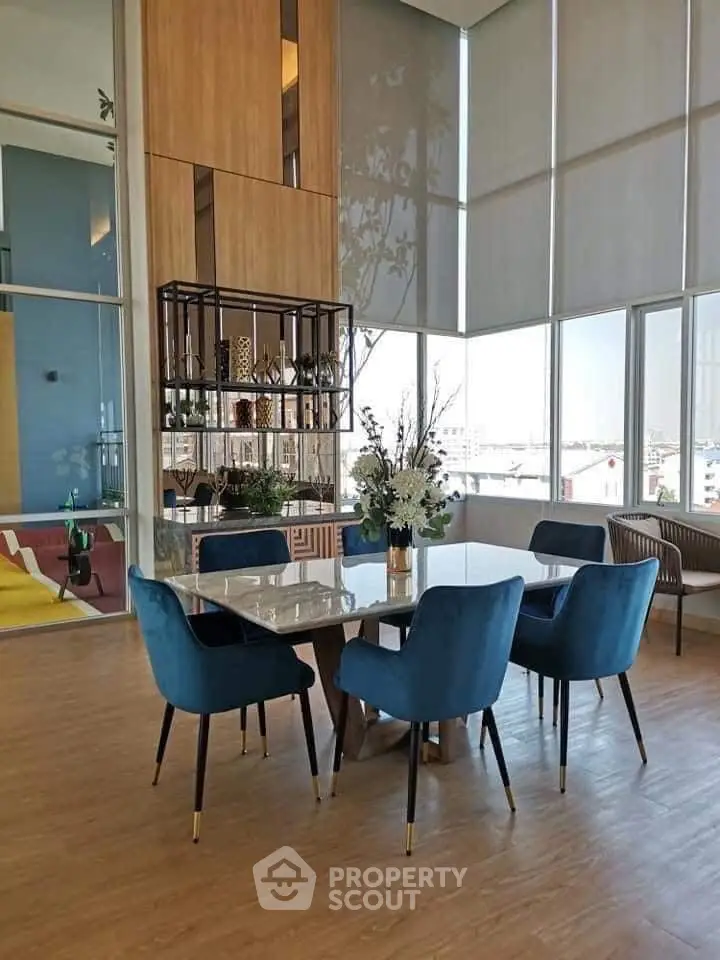 Elegant dining area with modern decor and large windows offering natural light.