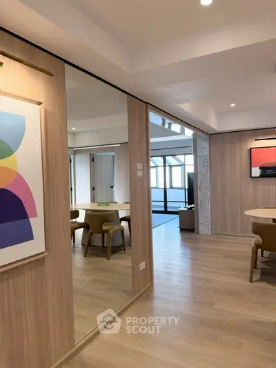 Modern open-plan living area with stylish decor and wooden flooring