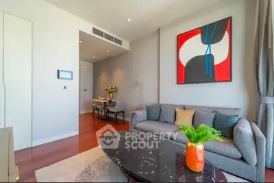 Modern living room with stylish decor and vibrant artwork, featuring a cozy sofa and elegant coffee table.