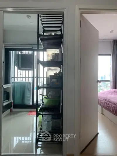 Modern apartment with open balcony and cozy bedroom, perfect for urban living.