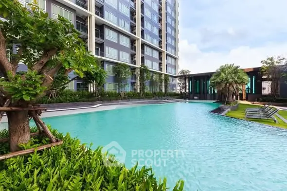Luxurious apartment complex with stunning pool and lush greenery
