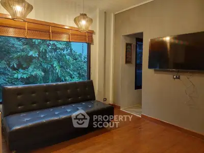 Cozy living room with leather sofa and large window view