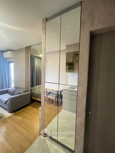 Modern apartment interior with mirrored wall and cozy living area