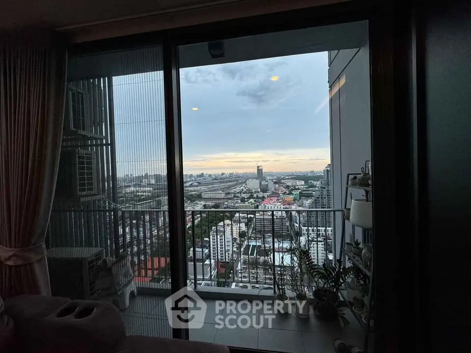 Stunning cityscape view from a modern high-rise balcony at sunset.