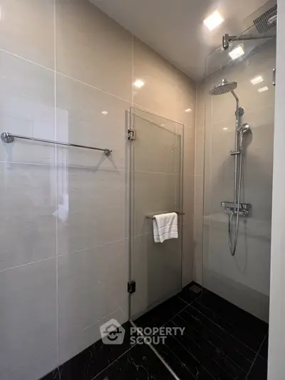 Modern bathroom with glass shower enclosure and sleek tile design
