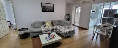 Spacious modern living room with sleek furniture and open kitchen layout in a stylish apartment.