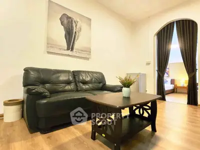 Cozy living room with black leather sofa and elegant decor