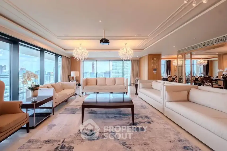 Luxurious living room with panoramic city views and elegant chandeliers.