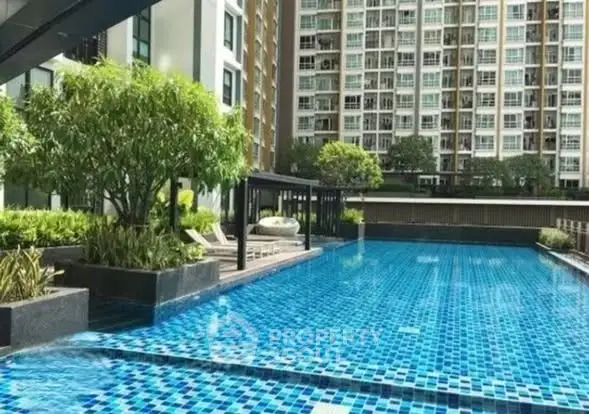 Luxurious condominium with stunning outdoor pool and lush greenery, perfect for relaxation and leisure.