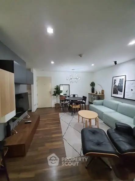 Modern living room with stylish furniture and wooden flooring, perfect for cozy gatherings.
