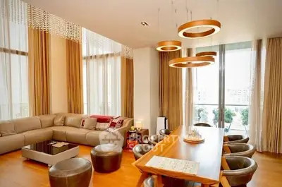 Luxurious living room with modern decor and large windows offering natural light.