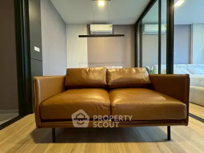 Modern living room with stylish brown leather sofa and sleek design elements.