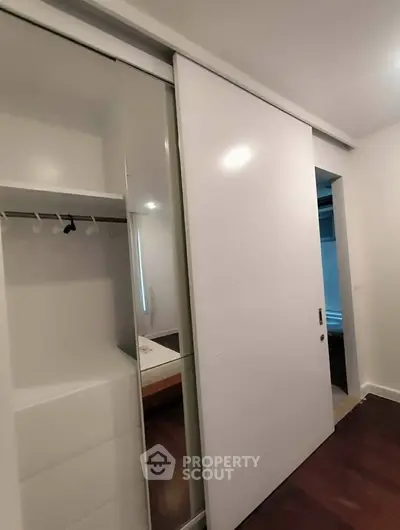 Modern bedroom with sleek sliding closet doors and minimalist design