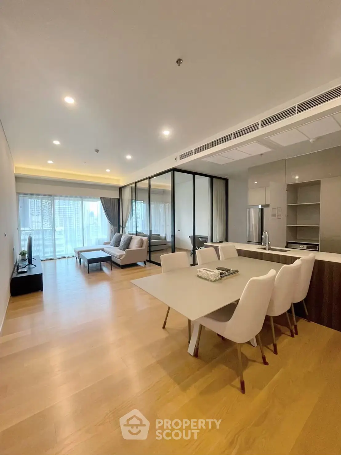 Spacious modern living room with open kitchen and large windows in luxury apartment