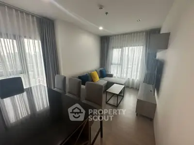 Modern living room with stylish furniture and large windows in a contemporary apartment.