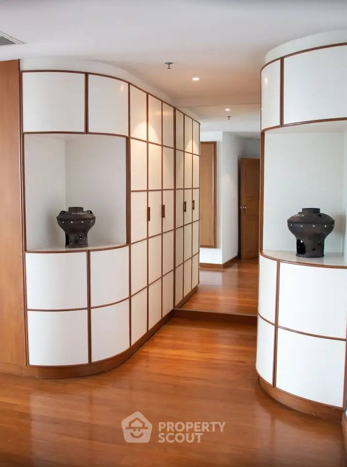 Elegant hallway with modern wooden paneling and decorative vases