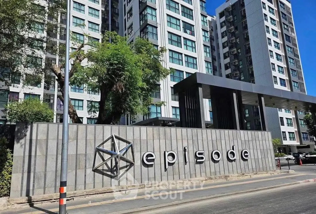 Modern apartment building with stylish facade and prominent entrance sign