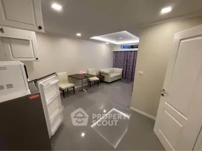 Spacious modern living room with sleek furniture and open layout, perfect for relaxation and entertainment.