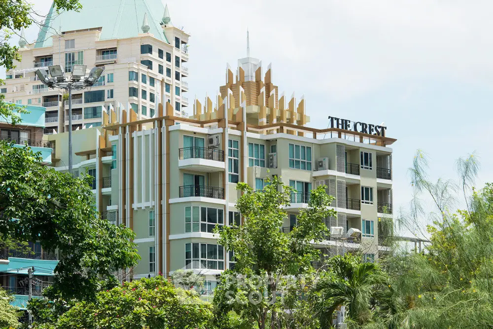 Luxurious modern apartment building with unique architectural design and lush greenery surroundings.